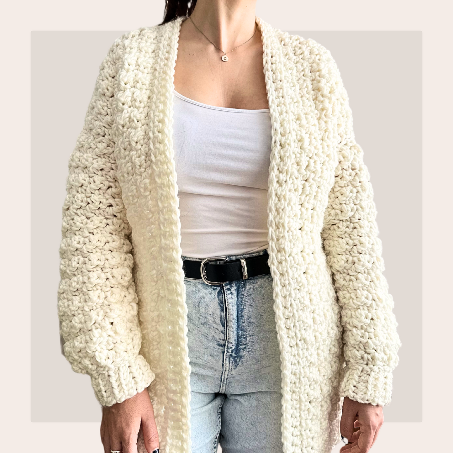 front shot of lemon peel cardigan worn over a white vest and blue jeans.