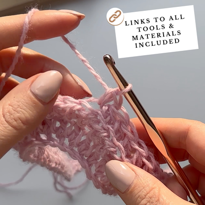 Close-up of hands crocheting pink yarn with a crochet hook, on a light gray background.
